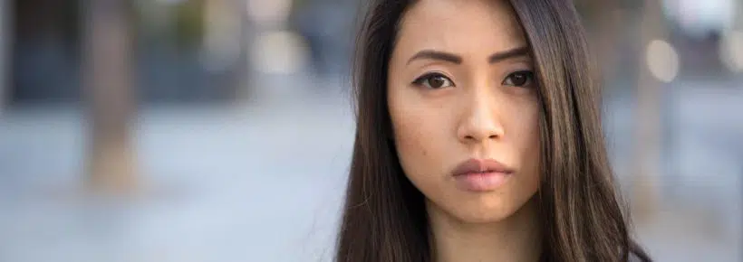 Young Asian woman serious face