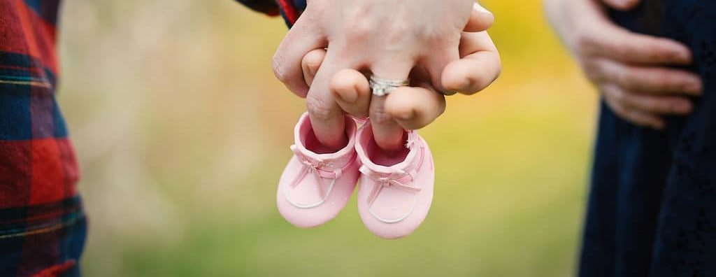 Couple with baby shoes