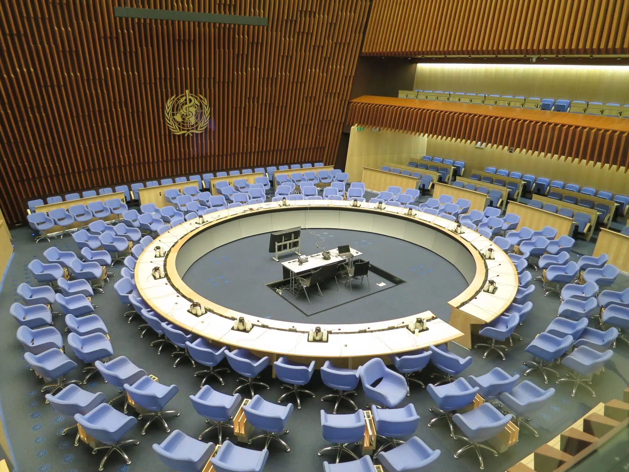 "<a href="https://commons.wikimedia.org/wiki/File:World_Health_Organization_Executive_Board_Room.JPG" target="_blank" rel="noopener">World Health Organization Executive Board Room</a>" by Thorkild Tylleskar is licensed under <a href="https://creativecommons.org/licenses/by-sa/3.0/deed.en" target="_blank" rel="noopener">CC BY-SA 3.0 Deed</a>.